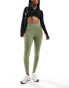 Фото #1 товара New Balance Linear Logo sleek 25 inch high rise leggings in olive green