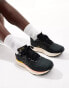 New Balance Evoz running trainers in black and pink