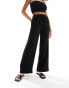 In The Style x Perrie Sian exclusive textured tie waist wide leg beach trousers in black