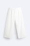 WIDE-FIT PLEATED TROUSERS