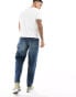 Фото #4 товара ASOS DESIGN tapered jeans in dark wash blue