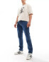 Фото #4 товара Wrangler Texas slim fit jeans in mid wash