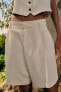 High-waist pleated bermuda shorts