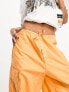 Weekday Unisex parachute baggy trousers in orange exclusive to ASOS