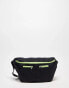 Public Desire Ethan pocket detail tech bumbag in black and lime green