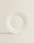 Earthenware dinner dish with raised-design edge