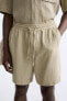 CREASED-EFFECT BERMUDA SHORTS