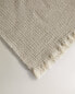 Waffle-knit cotton towel with fringing