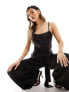 Flounce London – Seitlich gebundener Jumpsuit aus Satin in Schwarz mit Wasserfallausschnitt