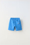 Plush bermuda shorts with label detail