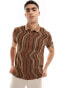 ASOS DESIGN polo in brown and beige wavy stripe