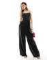 Flounce London – Seitlich gebundener Jumpsuit aus Satin in Schwarz mit Wasserfallausschnitt