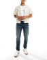 Фото #1 товара ASOS DESIGN skinny jeans with yellow tint in dark wash blue