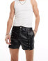 ASOS DESIGN slim leather look shorts with lace up details in black