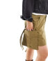 Фото #1 товара COLLUSION Plus festival utility mini skirt with drop pocket and tab detail in khaki