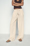 CREASED-EFFECT WIDE-LEG TROUSERS