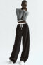 Trousers with satin waistband