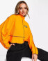 ellesse – Sweatshirt in Orange mit Kontrastnaht