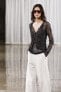 Semi-sheer creased-effect beaded jacket