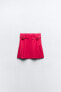Box pleat mini skirt with buckles