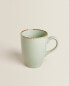 Porcelain mug with antique finish rim