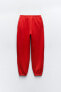 Plush jogging trousers with slogan