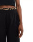 ASOS DESIGN longline shorts with leopard waistband in black