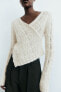 Asymmetric cropped knit sweater