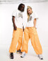 Weekday Unisex parachute baggy trousers in orange exclusive to ASOS