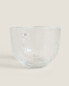 Glass cup with raised design