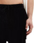 Фото #4 товара ASOS DESIGN oversized ribbed velour shorts in black with cargo pockets