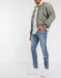 Фото #1 товара ASOS DESIGN skinny jeans in tinted light wash blue with rips