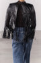 Short leather cape with fringing