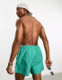 ASOS DESIGN swim shorts in short length in turquoise