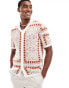 ASOS DESIGN knitted short sleeve button through polo in stone paisley pattern