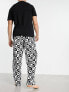 Фото #3 товара ASOS DESIGN pyjama set with t-shirt and trousers in black with fleece printed bottom