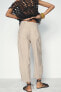 CHINO TROUSERS WITH DARTED HEMS