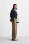 BELTED PLEATED TROUSERS