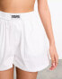 ASOS DESIGN Weekend Collective shorts with woven label in white