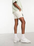 ASOS DESIGN slim shorter length denim cargo shorts with patch in ecru