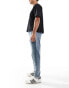 ASOS DESIGN tapered fit jeans with vintage tint in mid wash blue - MBLUE