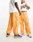 Weekday Unisex parachute baggy trousers in orange exclusive to ASOS