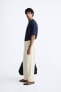 TEXTURED PLEATED TROUSERS