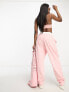 Фото #4 товара ASOS Design unisex co-ord relaxed joggers with prints in pink wash