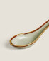 Porcelain spoon with antique-finish rim