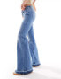 ONLY low rise super flared drop hem jean in mid wash