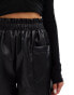 In The Style leather look stretch waist shorts in black