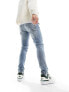 ASOS DESIGN skinny jeans in light blue wash with abrasions