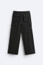 Creased-effect trousers with detachable detail