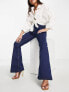 Фото #4 товара ASOS DESIGN Petite power stretch flared jeans in dark blue